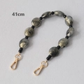 Detail of 41cm acrylic bead strap with grey marble pattern and gold metal buckles - 41cm