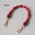 Detail of red acrylic beaded strap with marble pattern beads and gold lobster clasps - Olive and Cylindrical Style (Style 2) / 32cm