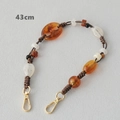 Detail view of 43cm amber acrylic bead chain with golden metal lobster clasps - 43cm