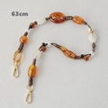 Detail of 63cm resin bead chain with amber oval beads and gold metal clasps - 63cm