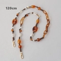 Detail view of 120cm amber acrylic bead strap with golden lobster clasps and braided rope - 120cm
