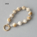 Macro detail of a 28cm acrylic marble bead phone chain with gold metal spring clasp - Marble Texture Mixed Style