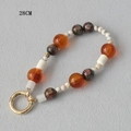 Detail of 28cm acrylic beaded phone strap with orange and marble beads and gold clasp - Orange Transparent Marble Style