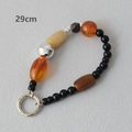 Close-up of 29cm acrylic beaded strap with orange and yellow beads and silver ring - 29 CM