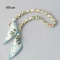Close-up of a 60cm gold chain strap interwoven with a green floral silk scarf detail - Light Green Floral (Gold Chain)