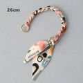 Detail of 26cm silk scarf woven handbag chain with light gold metal rings and bow - Colorful Collage