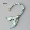 Close-up of a 26cm floral silk scarf bag handle with gold rings and bow detail - Light Green Floral