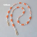 Detail van de 120 cm lange acryl en parel crossbody riem met gouden metalen karabijnsloten - Oranje-120CM