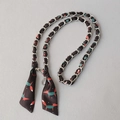 Detail view of woven metal chain with black silk scarf featuring red fox patterns - Black Fox (Silver)