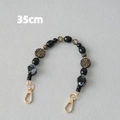 Detail of 35cm acrylic bead strap with leopard print and black marbled beads with gold clasps - Black-35CM