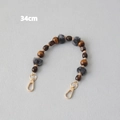Detail of 34cm wooden bead chain with grey faux fur balls and golden lobster clasps - Style 4 / 34cm