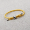 Close-up of bright yellow braided rope bracelet with adjustable silver metal slide clasp - Style A (Round) / Yellow