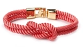 Detailed view of woven pink cord bracelet with central knot and polished gold magnetic clasp - Pink
