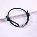 Detail of adjustable dark green braided rope bracelet with silver handcuff clasp closure - Dark Green