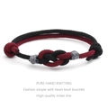 Detailed view of hand-woven red and black couple bracelets with concentric heart knot - Wine Red + Black