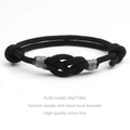 Close-up of handmade black woven concentric knot bracelet with detailed rope texture - Black