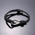 Adjustable black woven bracelet featuring a polished silver U-shaped metal shackle clasp - Black