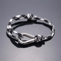 Braided black and white cord bracelet featuring a silver U-shaped metal horseshoe clasp - Black and White Camouflage
