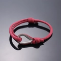 Adjustable red woven friendship bracelet featuring a silver heart-shaped clasp - Burgundy
