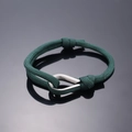 Deep green woven rope bracelet featuring a polished silver U-shaped metal buckle - Dark Green