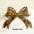 Detailed front view of a bow-shaped wooden wall shelf with snakeskin pattern texture - 22.5*30cm / Animal Pattern Style (ms10078)