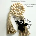 Detail showing a 90cm wooden bead tassel with ghost tag for Halloween curtain decor - Natural Wood Ghost Style (BS4351)