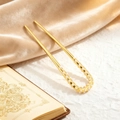 Detail of a U-shaped gold hair pin with white pearls on champagne velvet background - Gold Pearl Style