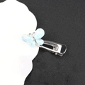 Detail of silver bow hair clip featuring an iridescent blue translucent butterfly design - Light Blue Butterfly