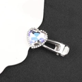 Close-up of heart-shaped iridescent gemstone hair clip with rhinestones on silver base - Transparent Single Heart