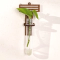 Minimalist dark wood wall plant holder with glass tube and green leaf cutting - Letter T Style (ms8517)
