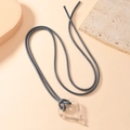 Minimalist transparent resin heart pendant necklace with long grey cord on warm stone - Transparent Gray