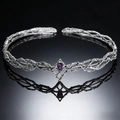 Macro shot of silver vine elf crown featuring a teardrop purple gem on a reflective surface - Silver Purple Rhinestone