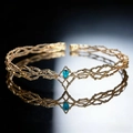 Detailed view of a golden elf crown with intricate metal vines and a blue teardrop gemstone - Gold With Blue Rhinestone