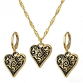Close-up of heart-shaped necklace and earrings set with vintage black etched patterns - Antique Gold Set (F1304)
