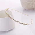 Elegant gold wavy headband with white pearls and sparkling crystals on a white porcelain cup - Rhinestone Pearl Golden Style (C8215)
