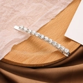 Elegant silver hair clip with fourteen sparkling rhinestones on a wooden base - Silver