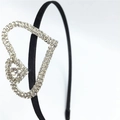 Detailed side view of black satin headband with double sparkling rhinestone heart decor - Double Heart Rhinestone Style (C9513) / Silver