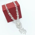Detailed macro view of a silver rhinestone necklace with geometric links and a tassel pendant - Marquise Tassel Style / Silver