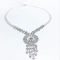 Detailed view of silver rhinestone tassel necklace with a sparkling round central pendant - Round Ring Tassel Style / Silver