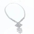 Detail of silver rhinestone necklace with diamond-shaped pendant and tassel drop elements - Rhombus Tassel Style / Silver