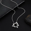 Silver starburst geometric pendant on a box chain draped over a black leather bag - Geometric Pendant Necklace / 60+5cm