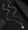 Macro shot of a silver starburst pendant with pave crystals on a layered chain - Starburst Pendant Necklace / 50+5cm