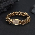 Close-up of golden Cuban link bracelet with diamond accents on a dark textured surface - Gold Color Bracelet