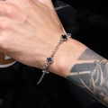 Detail of titanium steel chain bracelet with black cross charms on model wrist - Chain Style / 17+5cm / Black Spliced Cross (PG0695)