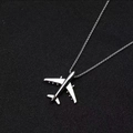 Macro shot of a silver airplane pendant with realistic wing details on a sleek metal chain - Airplane + 60cm Titanium Steel Chain