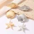 Elegant gold and silver starfish and seashell hair clips set on silk fabric - Full Marine Life Collection Style