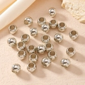 Polished silver metal beads for DIY jewelry and hair accessories on a minimal background - Silver