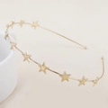 Detailed close-up of a golden headband featuring textured metallic stars on white ceramic - Single-layer Gold