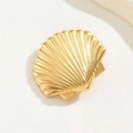 Elegant gold shell hair clip with fine radial textures in a minimalist sea style - Gold Shell Style
