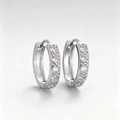 Silver copper hoop earrings featuring five micro-pave cubic zirconia stones in huggie style - Silver